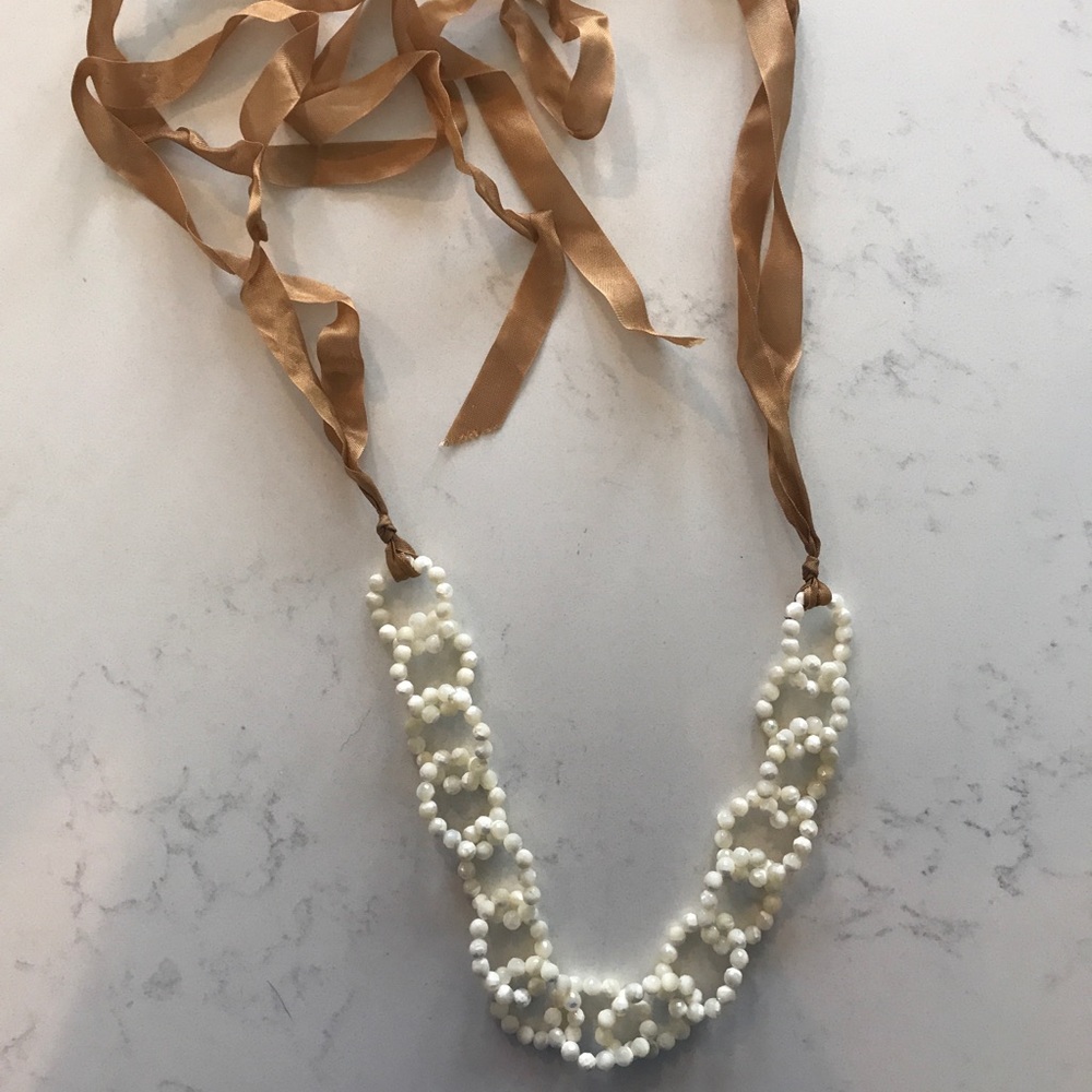 Statement necklace. Ribbon tie.